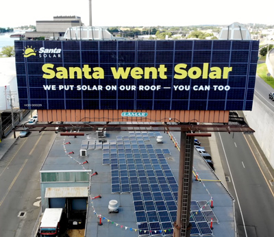 billboard that says Santa went Solar above Santa Energy office