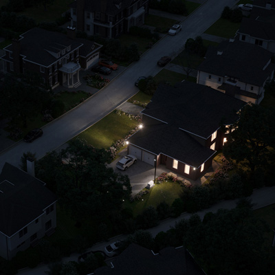 birds eye view of dark neighborhood at night and one house's lights on